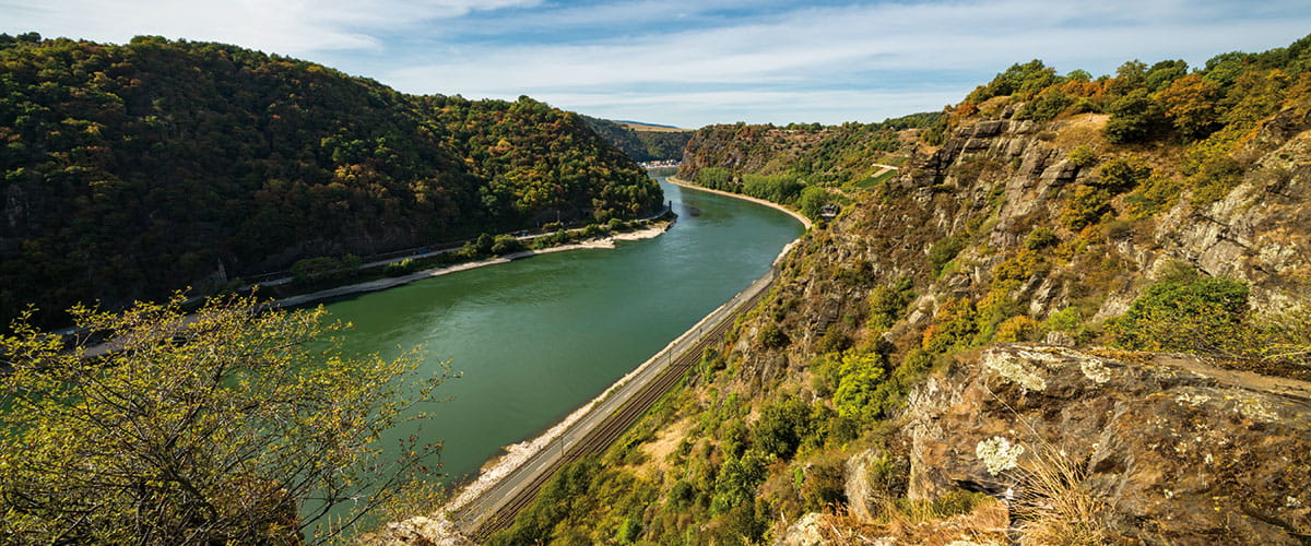 Cruise ship on the Rhine. The famous Loreley rock is visible in the distance.